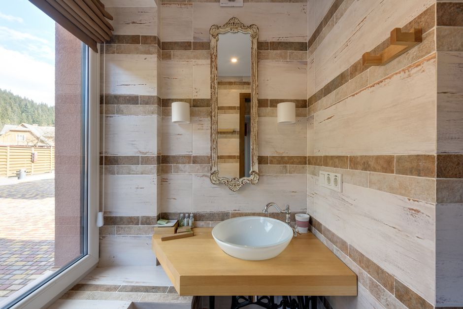 minimalist modern bathroom with wood vanity and warm lighting