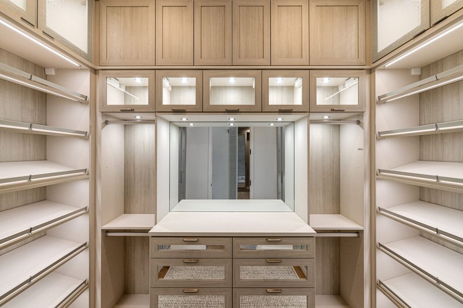 minimalist walk-in closet with natural wood shelves and soft lighting
