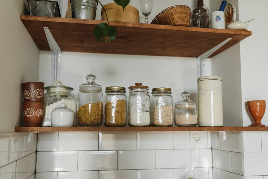 modern kitchen open shelf pantry with organized jars and wooden details