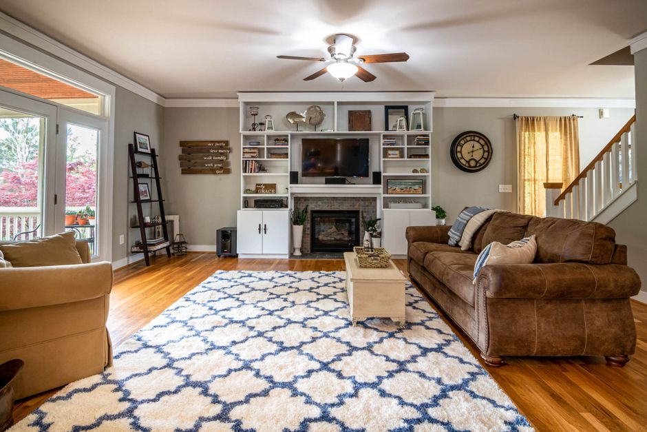 modern living room with large ceiling fan and warm lighting