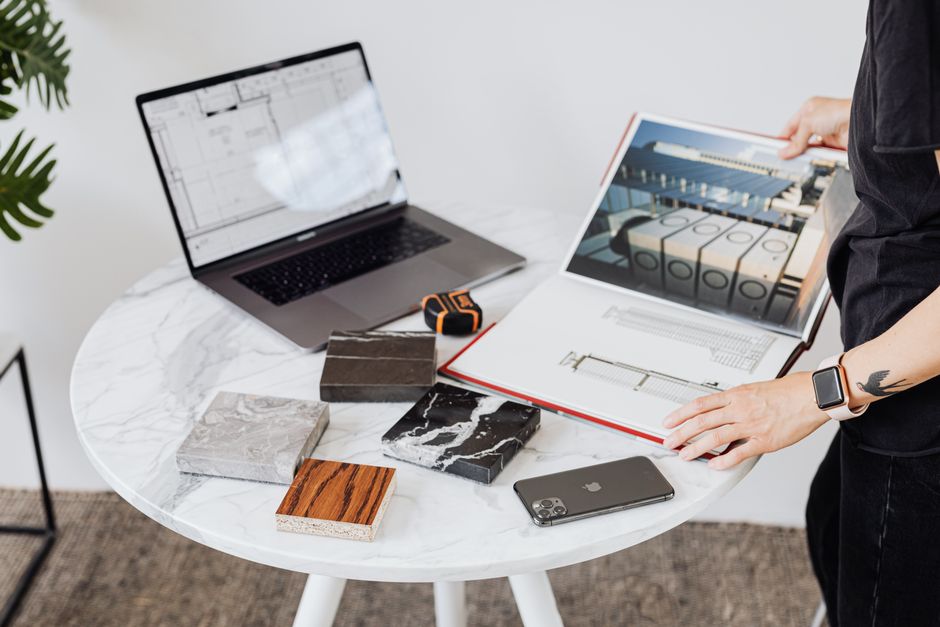 interior design studio workspace with blueprints and wood samples