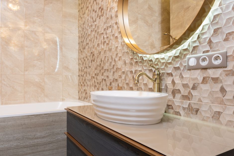 modern bathroom sink with ceramic tiles and warm lighting