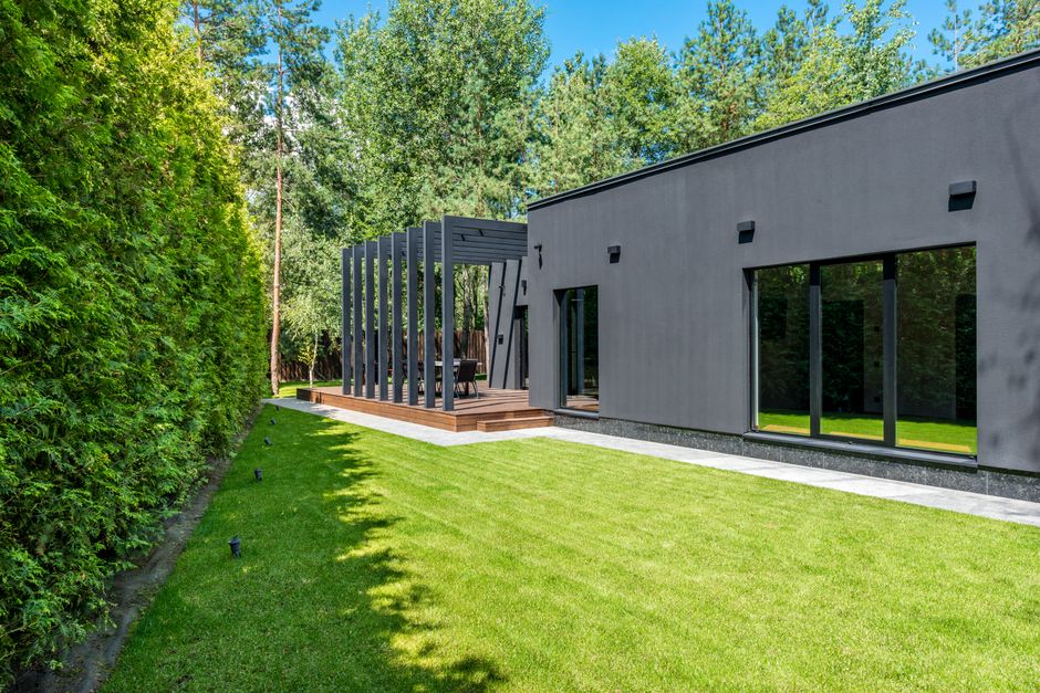 modern simple house exterior with garden and wooden deck