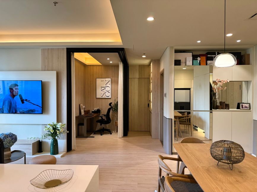 Modern home office nook connected to an open-plan living room with natural light