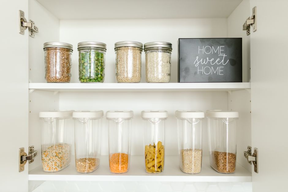 Organized modern kitchen pantry with various food items and kitchenware