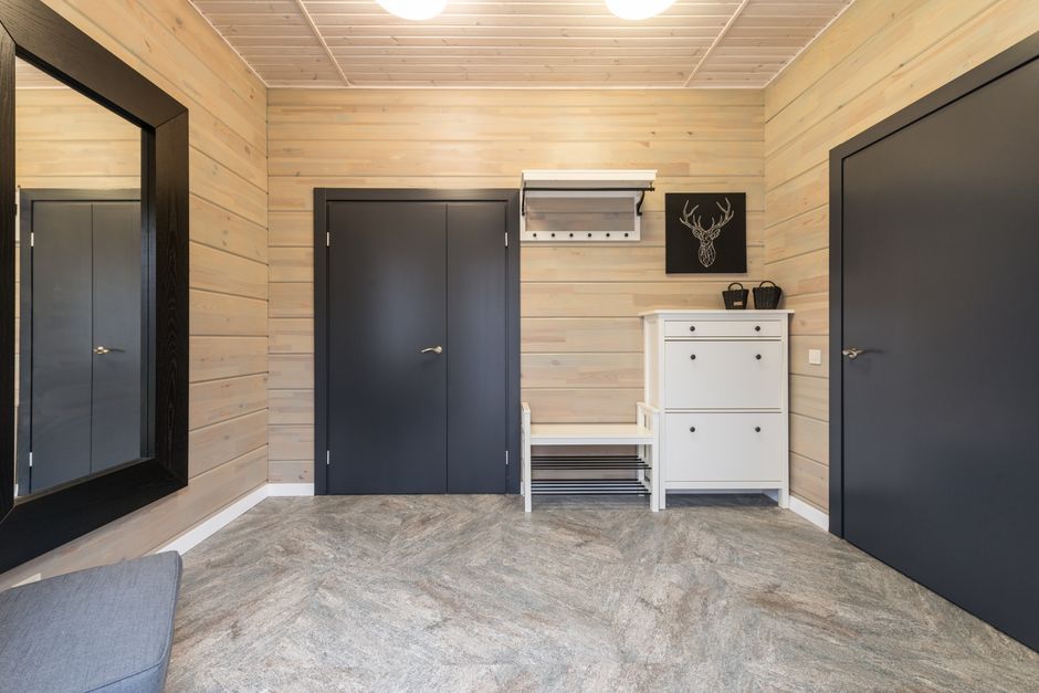 minimalist wooden entryway with hidden storage and natural light