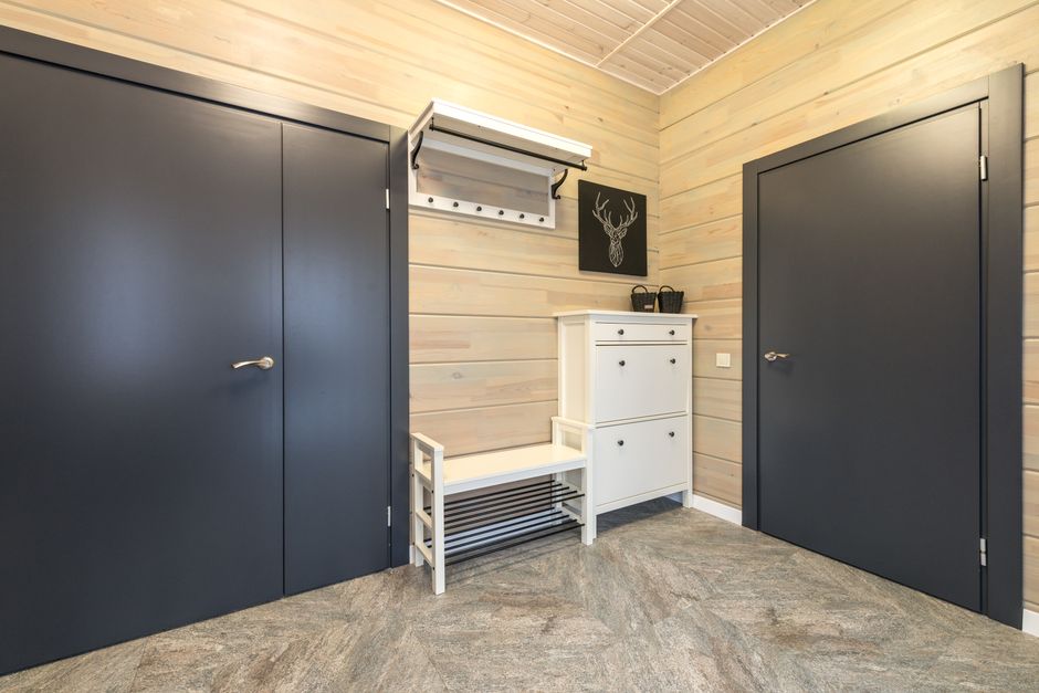 modern minimalist home entrance with wooden shoe rack and organized hallway