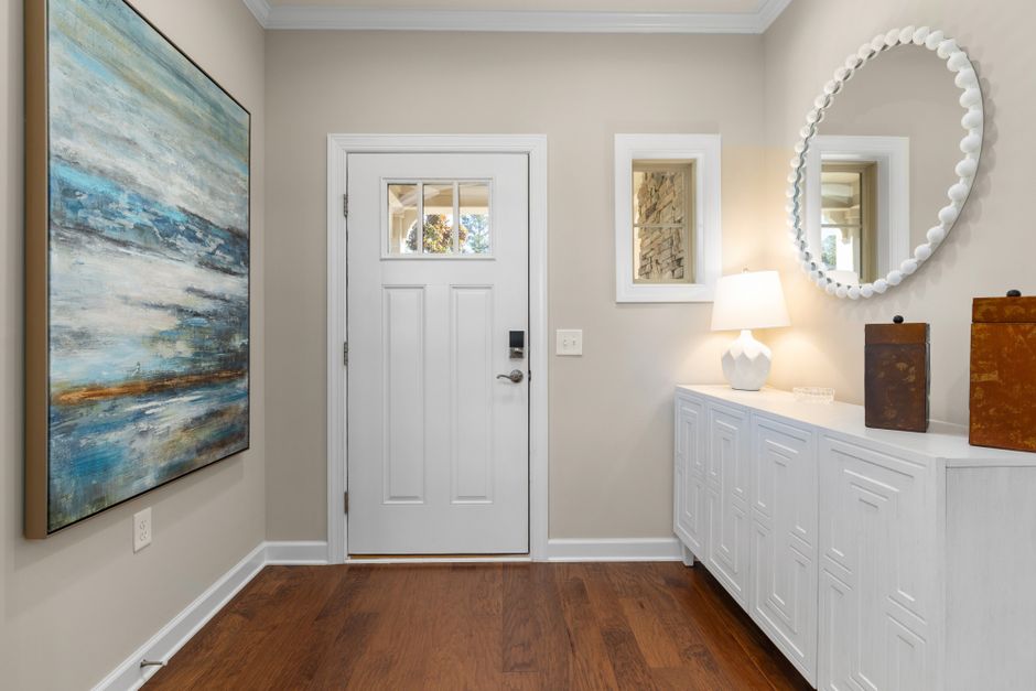 bright minimalist foyer with natural wood elements and soft lighting