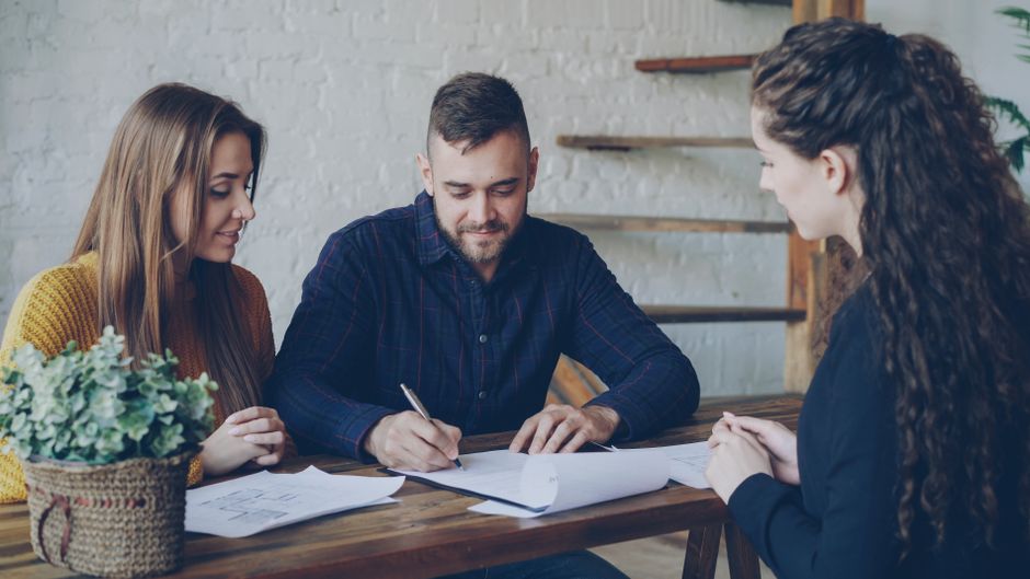 couple planning future home finance documents minimalist desk